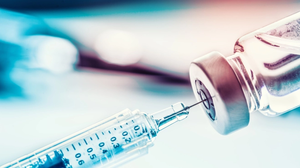 Close-up medical syringe with a vaccine.,  
