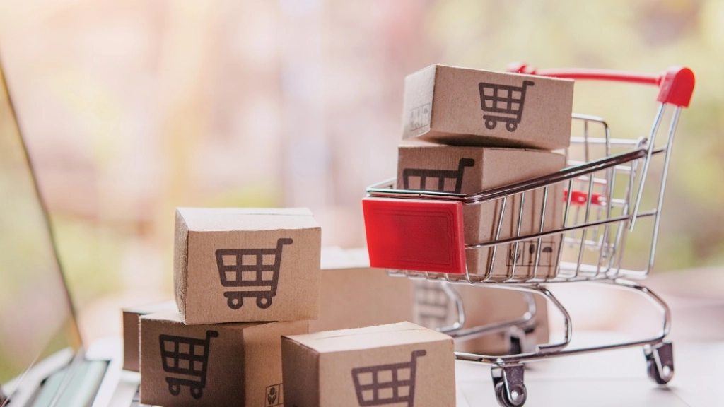 Shopping online concept - Parcel or Paper cartons with a shoppin, Shopping online concept - Parcel or Paper cartons with a shopping cart logo in a trolley on a laptop keyboard. Shopping service on The online web. offers home delivery.