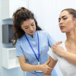 woman-doctor-osteopath-in-medical-uniform-fixing-woman-patients-shoulder-and-back-joints-in-manual-therapy-clinic-during-visit-professional-osteopath-during-work-with-patient-concept, <a href=